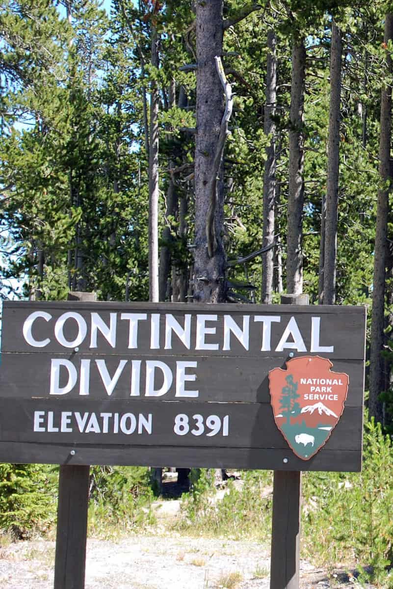 The continental divide sign in Yellowstone showing an elevation of 8391 feet