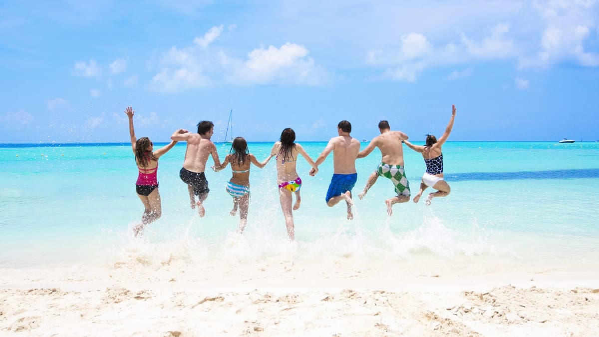 Group of fun-loving young adults playing in the beautiful ocean
