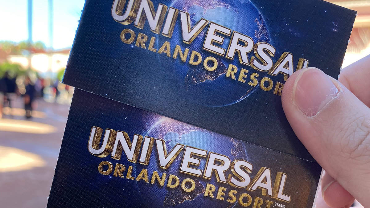 Hand holding 'Universal Studios tickets' famous world theme park and movie company- Orlando, USA