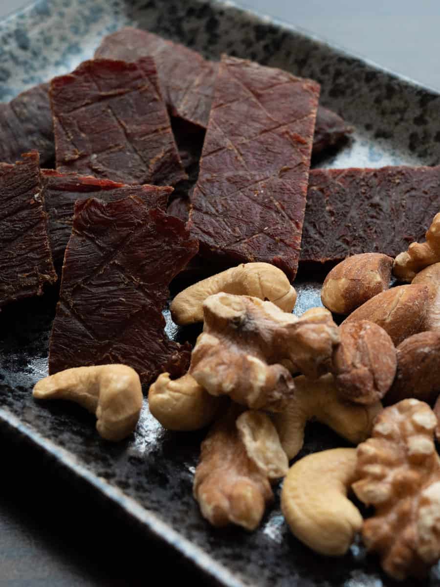 Beef jerky and nuts on the plate