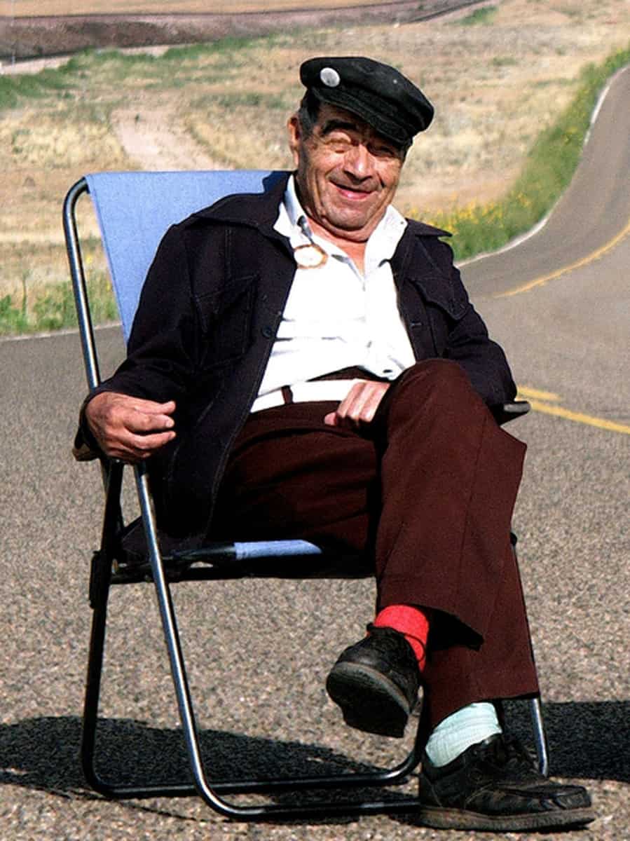 Juan Delgaldillo sitting on a lawn chair with mismatched socks at route 66 road