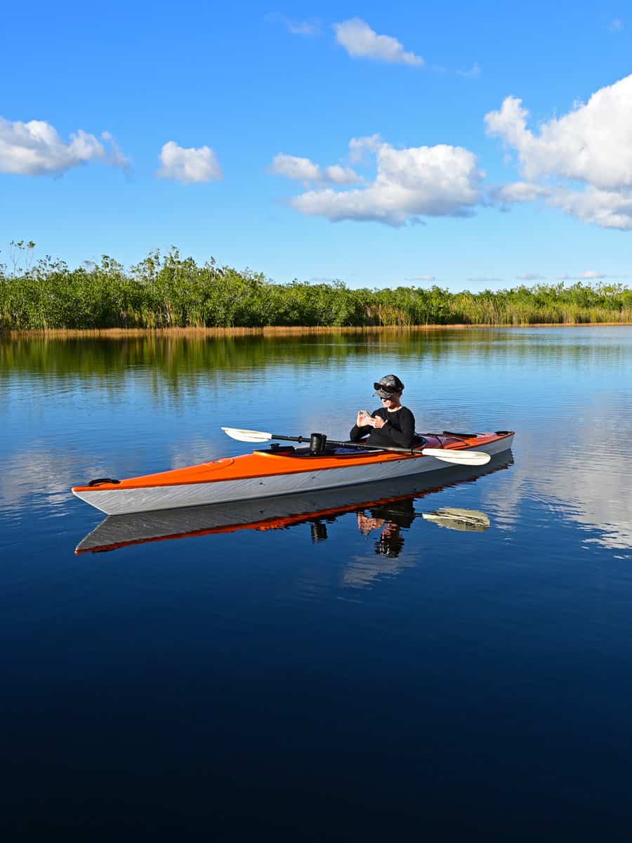 Woman kayaking on Nine Mile Pond in Everglades National Park, Florida on calm winter