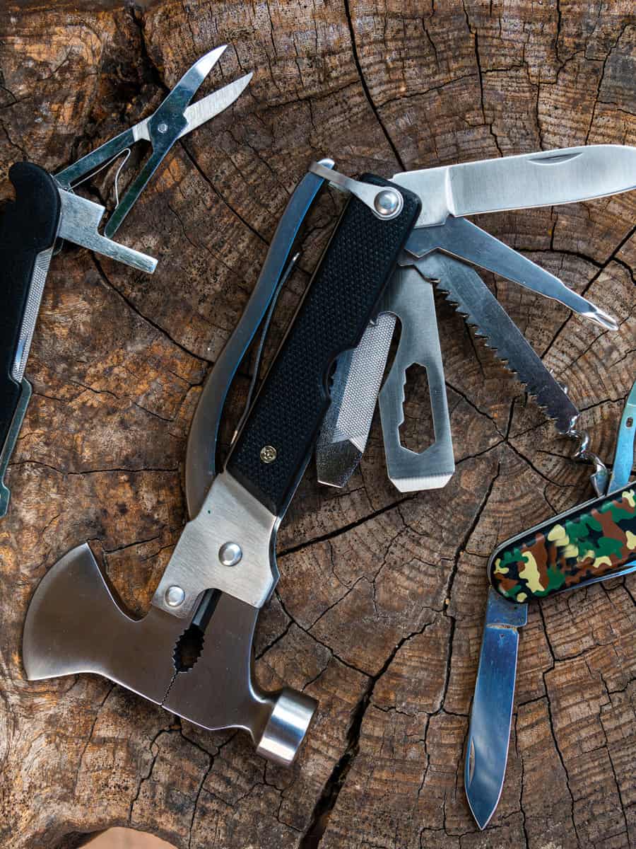 multi purpose tools on rustic wooden table ,camping and survival tools for every day