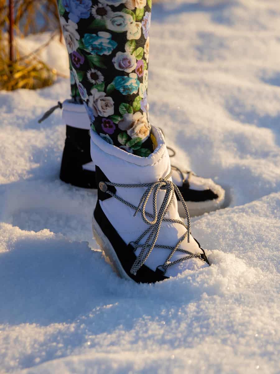 Walking in the snow in insulated waterproof snow boots