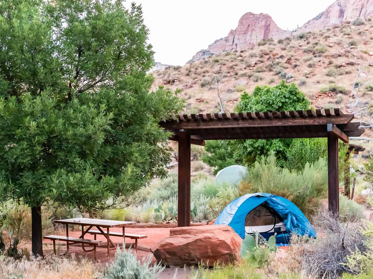 Zion National Park in Utah morning with tent on camp site at Watchman Campground with picnic table and pergola cover