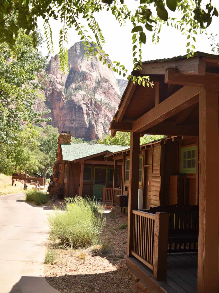 Zion National Park. Zion Lodge vintage cabins with porch, rocking chairs, a petite table; and, a cozy natural stone gas fireplace