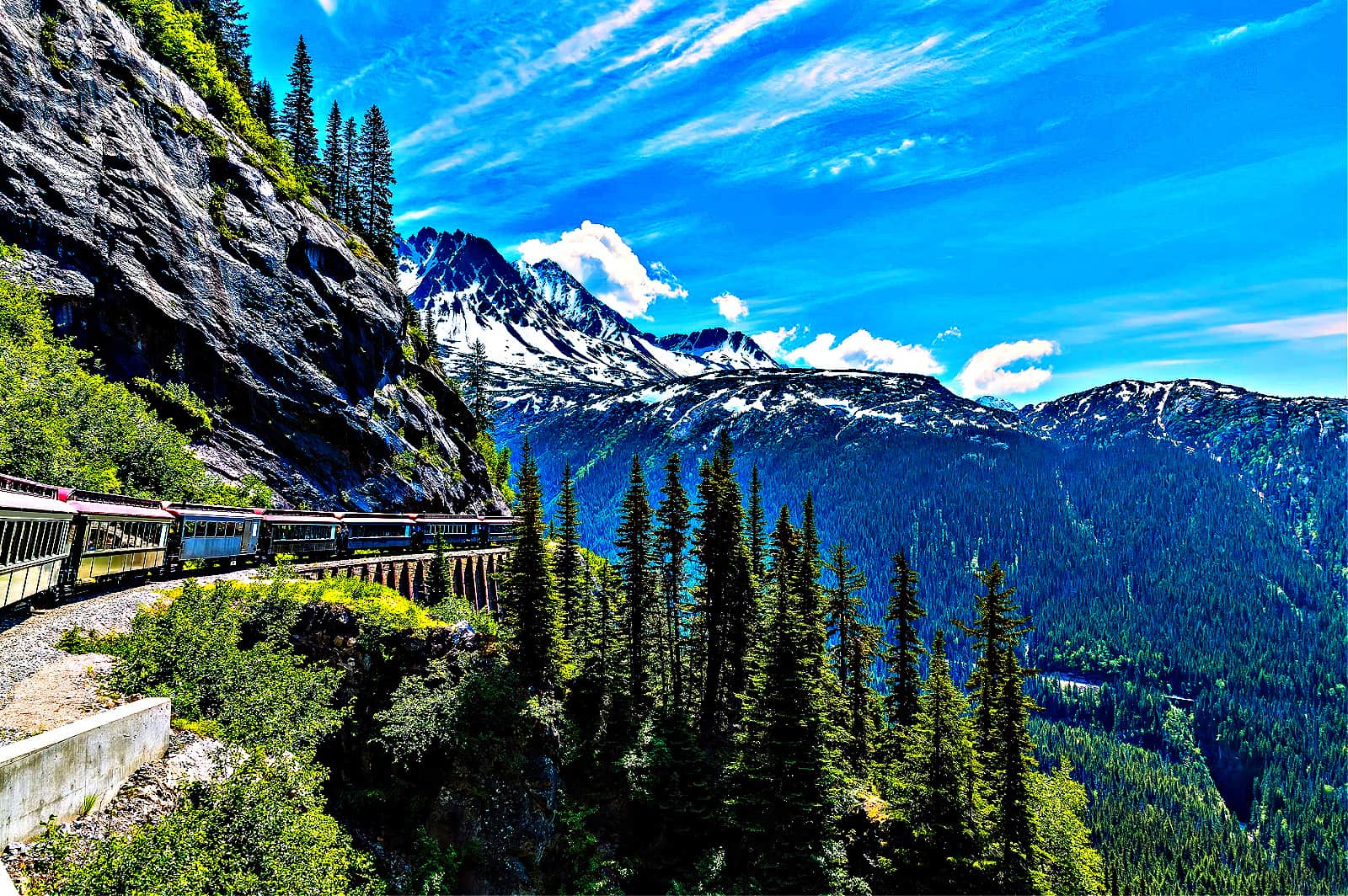 A view looking back from a train on the White Pass and Yukon railway on a bridge near Skagway, Alaska in summertime