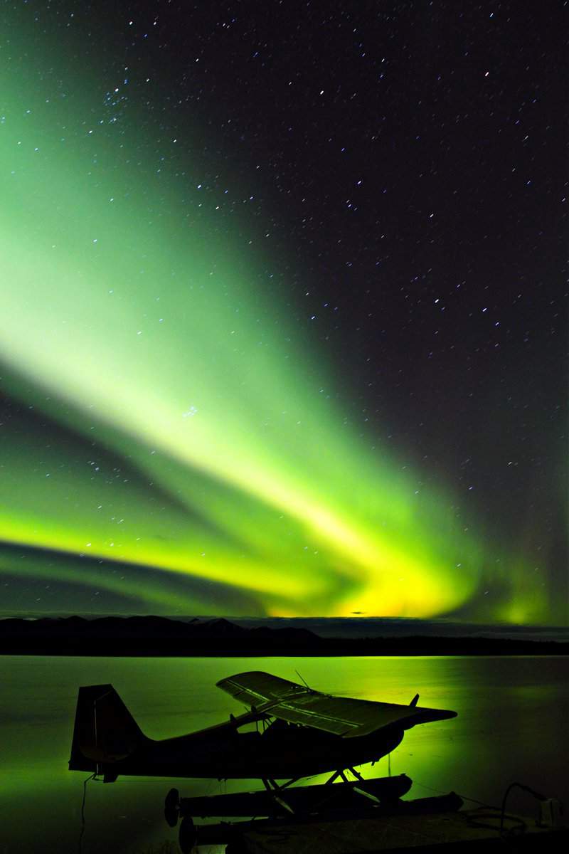 Aurora Borealis Northern Lights over Lake with Float Plane in Foreground at Bettles Field in Alaska