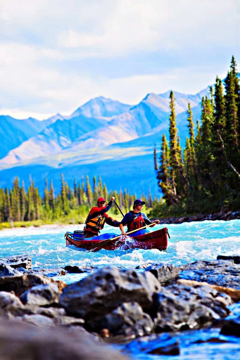 Two young men canoeing a whitewater river in the far north of North America.