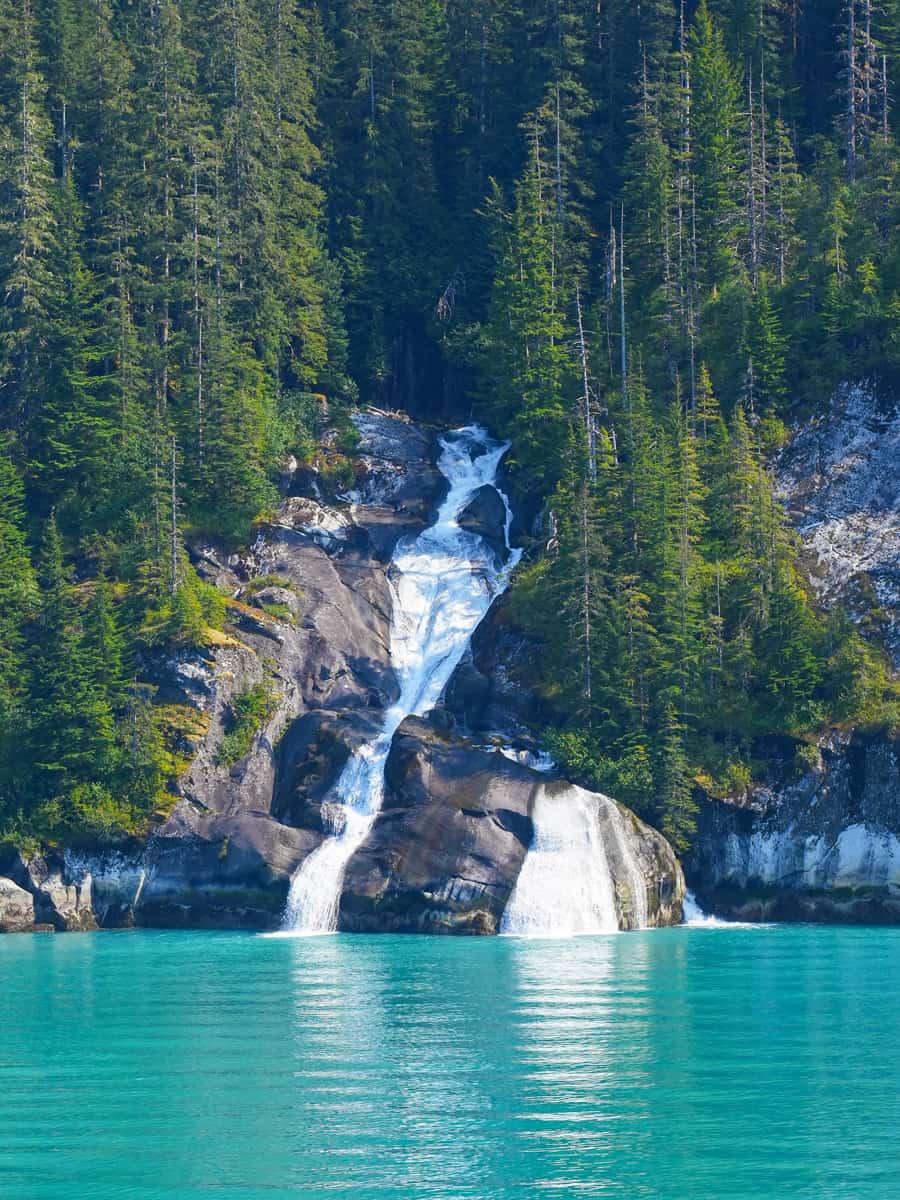 Waterfall of ice water flowing in the Pacific Ocean in the Tracy Arm Fjord near Juneau in southeastern Alaska, USA