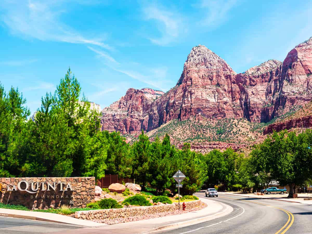 Zion National Park road street in Utah and town city sign for expensive La Quinta hotel lodging accommodation