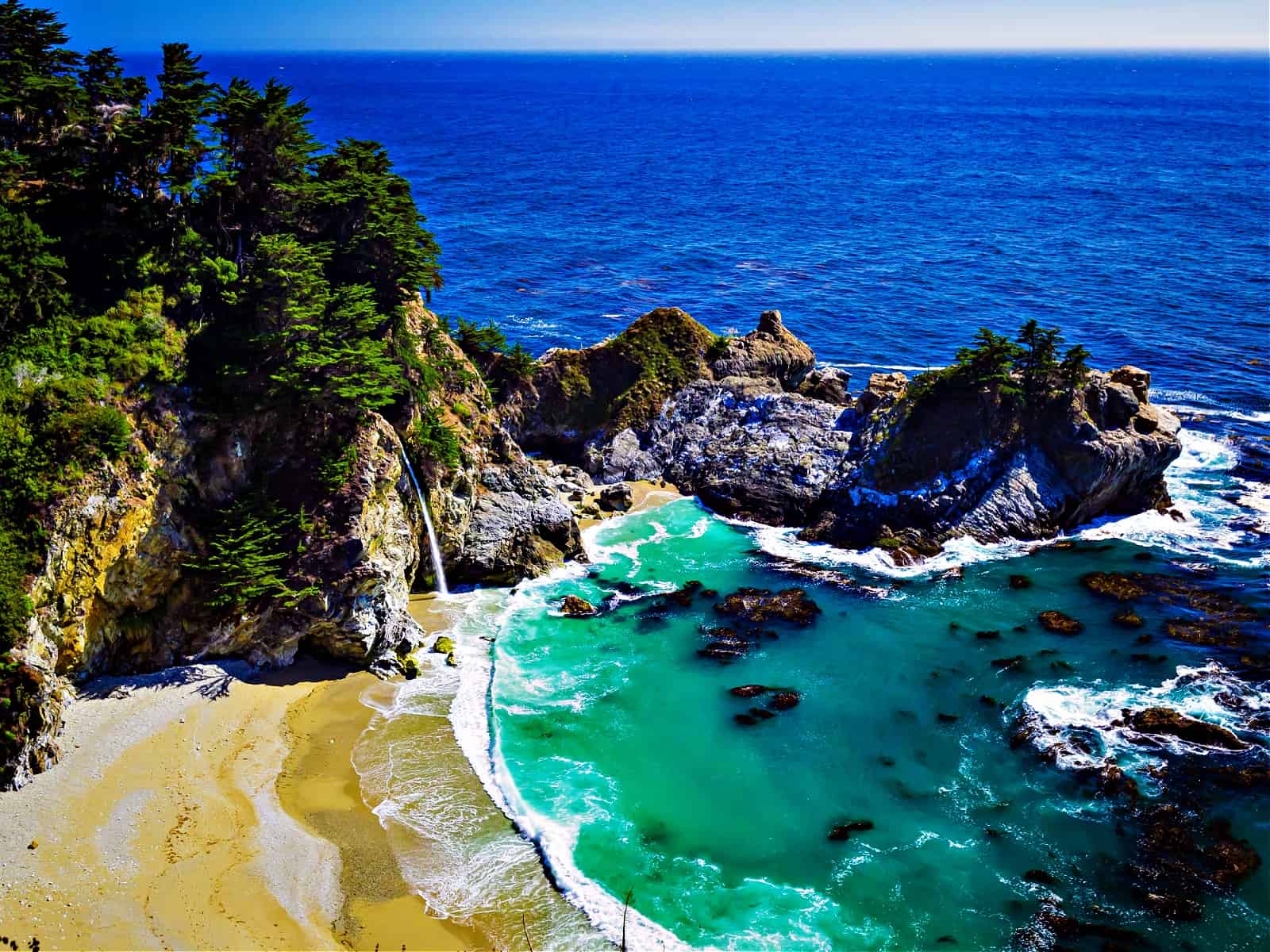 Aerial view of Water Fall McWay Falls Julia Pfeiffer Burns Park Big Sur California. McWay Falls a waterfall empties directly into the ocean.