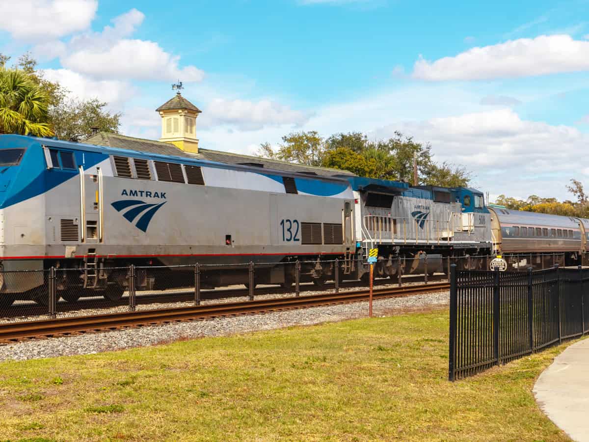 Amtrak train locomotive engine pulling into train station platform in Florida