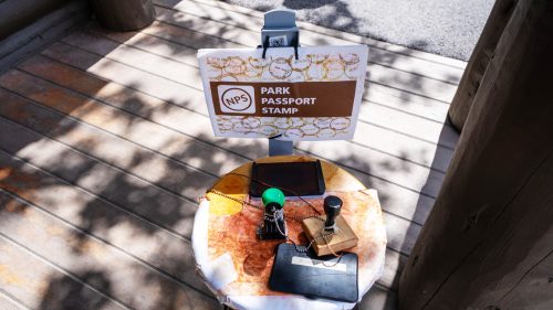 National Park passport stamp station for tourists, posted outside the Jenny Lake Visitor Center in Grand Teton National Park 1600x900