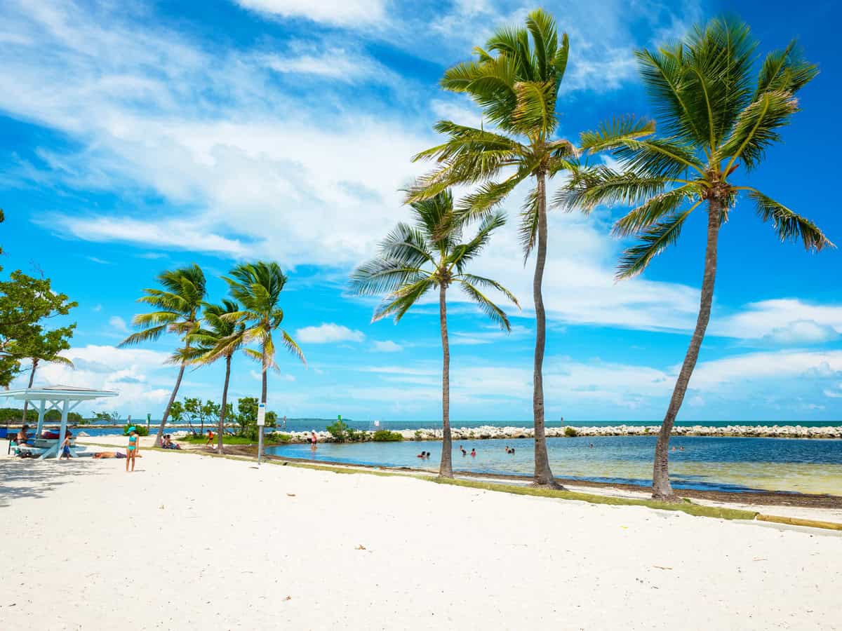 Visitors enjoying the beach lagoon in the scenic Harry Harris Park in the popular Florida Keys.
